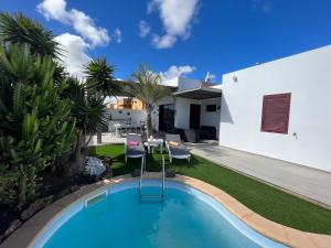 ein Swimmingpool im Hinterhof eines Hauses in der Unterkunft Villa Papi in La Oliva