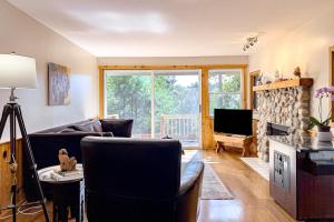 a living room with a couch and a tv at Lucy Lake Lookout in Lac du Flambeau