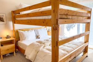 a bedroom with two bunk beds and a window at Lucy Lake Lookout in Lac du Flambeau
