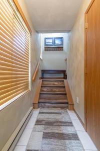 a hallway with wooden stairs and a window at Seven Springs 2BRLoft Premium Condo, sleeps 11! condo in Champion