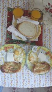 a table with three plates of food on it at Welcome Guest House in Shkodër