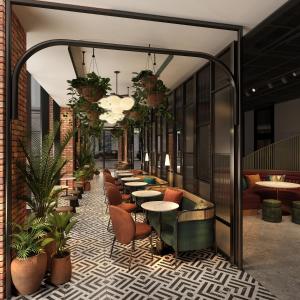 a restaurant with tables and chairs and plants at The Halyard Liverpool, Vignette Collection, an IHG Hotel in Liverpool