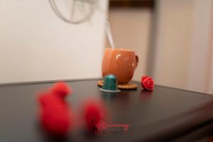 an orange coffee cup sitting on top of a table at Coral 5 for 2 Pax City Wi-Fi Free -By EasyLife Swiss in Lugano