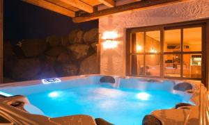 a jacuzzi tub in a house at night at Chalet Schönbuchet in Mauth