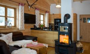 a living room with a wood stove in a room at Chalet Schönbuchet in Mauth