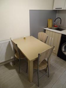 a table and chairs in a small kitchen at Vake Super Quiet and Comfy Apartment with a Yard in Tbilisi City