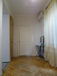 an empty room with a door and a chair at Vake Super Quiet and Comfy Apartment with a Yard in Tbilisi City