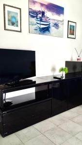 a black entertainment center with a flat screen tv at DGS APARTHOTEL in Trapani