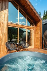 a hot tub on the deck of a house at Terra Resort in Topliţa