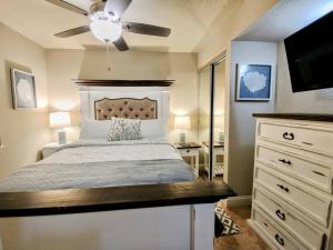 a bedroom with a bed with a ceiling fan and a dresser at Escape to Clearwater - Couples or families in Hot Springs