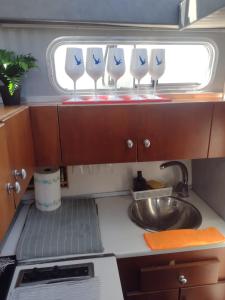 a kitchen with four wine glasses on the counter at Yach Boat Experience in Barcelona