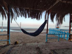 a hammock hanging from a hut on a beach at White palace camp (ex camp David) in Nuweiba