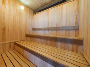 a sauna with wooden paneling and wooden shelves at APA Hotel Takasaki Ekimae in Takasaki