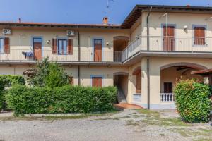 a large house with a balcony and bushes at RHOme 8 - 4 minutes from Rho Fiera in Rho