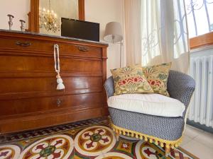 a living room with a chair and a dresser at At Fourth in Cagliari +19 photos