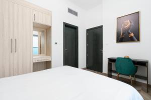 Postel nebo postele na pokoji v ubytování The Elite Apartment