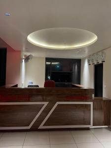 a lobby with a reception desk with a circular ceiling at Redbell Suites Kizhisseri in Kondotti