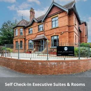 una casa de ladrillo con un cartel delante de ella en Eton House - Self Check-In Serviced Studios & Rooms en Yeovil