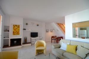 a living room with a couch and a fireplace at Puig sa Guilla 1C B3 in Pals