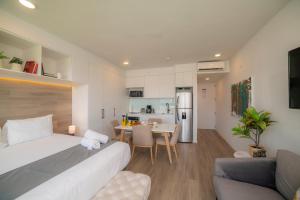 a bedroom with a bed and a dining room at BEE Suites Escalante in San José