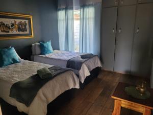 Postelja oz. postelje v sobi nastanitve 29B Zebra Street - InHimwe Guesthouse