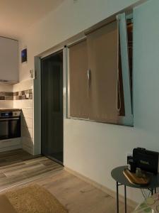 a kitchen with a sliding glass door and a table at Sanska 25 in Dušanovac (historical)