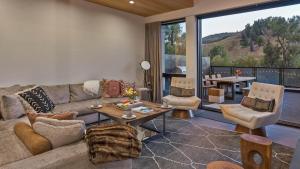 a living room with a couch and a table at Butterfly Lofts - West in Steamboat Springs