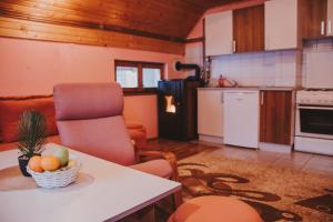 a kitchen with a table with a bowl of fruit on it at Guest house SAMM in Šišava