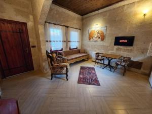 a living room with a couch and a table at Key of Cappadocia - House of Eos in Avanos