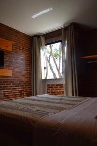 Postel nebo postele na pokoji v ubytování Chalés Estrada Real