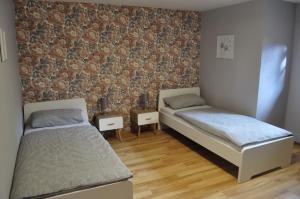 a bedroom with two beds and a brick wall at Ferien/Monteurwohnung Volling in Lengede