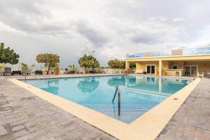 a large swimming pool in front of a building at serendipity on the beach Ocho Rios in Saint Annʼs Bay