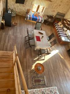 an overhead view of a living room with a table and chairs at Stone house with private infinity pool in Sarılar