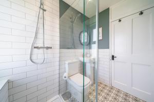 a bathroom with a toilet and a shower at Caddie's Cottage on Eden View Estate in St Andrews
