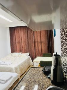 a hotel room with two beds and a blender at Red House Fatih in Istanbul