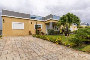 a house with a driveway in front of it at serendipity on the beach Ocho Rios in Saint Annʼs Bay