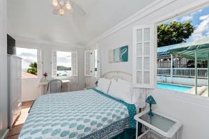 a bedroom with a bed and a view of a pool at At Home in the Tropics in Charlotte Amalie