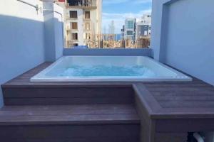 a hot tub on the balcony of a building at New Loft Apt Full AC King Bed in Santo Domingo