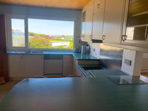 a kitchen with a large counter and a large window at Seaview Bungalow, Thurlestone, Beaches Nearby in Thurlestone