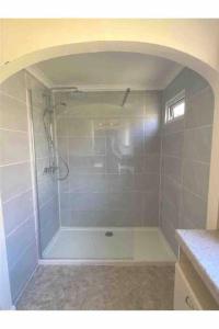 a bathroom with a shower with a white tub at Seaview Bungalow, Thurlestone, Beaches Nearby in Thurlestone