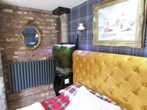 a bedroom with a bed and a painting on the wall at Woodston Fishing Station in Saint Cyrus