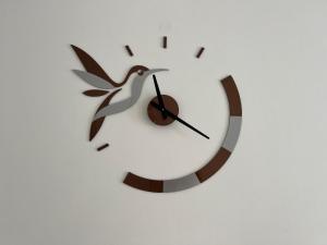 a clock on a wall with a bird on it at Saltwater Pearl - A charming 4 bed townhouse in Ilfracombe