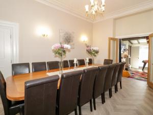 a conference room with a long table and chairs at The Keep in Llandudno