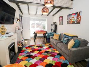 a living room with a couch and a colorful rug at The Keep in Llandudno