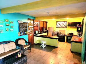 a kitchen with a table and a counter in a kitchen at Tortuguero Adventures Beach House in Tortuguero