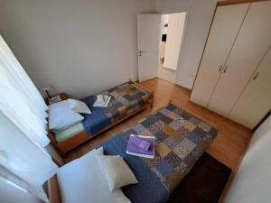 an overhead view of a bedroom with two beds and a rug at Apertment Kiki in Starigrad-Paklenica