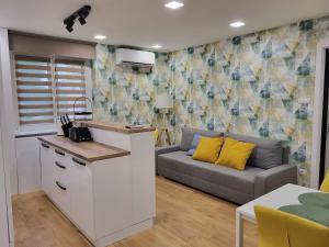 a kitchen and a living room with a couch at Kossuth 10 in Dunaújváros