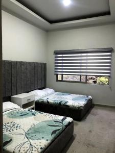 Un dormitorio con dos camas y una ventana. en Casa privada en Villa Bricia, en Cuernavaca