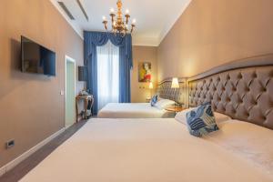 Letto o letti in una camera di Hotel Ristorante Ala d'Oro