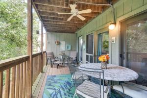 a porch with a table and chairs and a ceiling fan at Branson West Condo Balcony, Central Location in Branson West